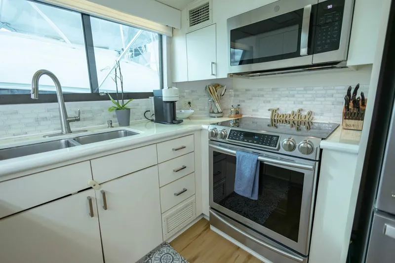  Yacht Photos Pics Modern kitchen in 1989 Hatteras Custom Cockpit yacht with stainless steel appliances.