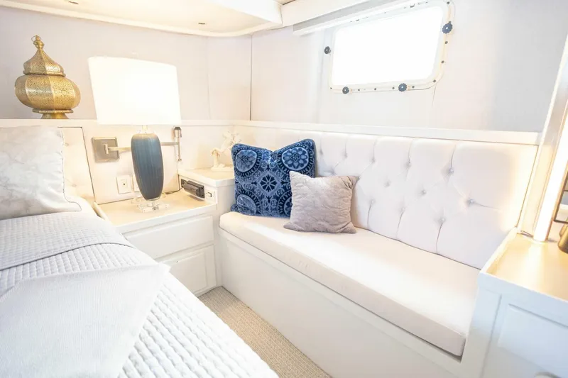  Yacht Photos Pics Luxurious 1989 Hatteras Custom Cockpit interior with elegant white seating and decorative pillows.