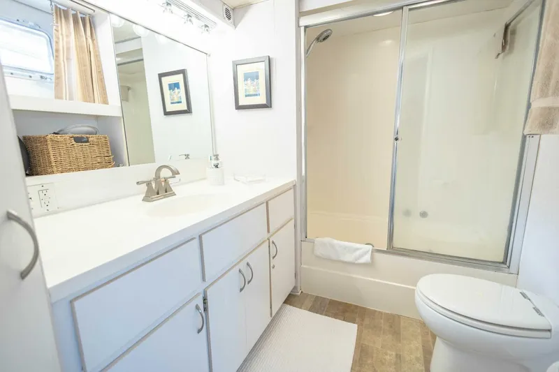  Yacht Photos Pics Bathroom in 1989 Hatteras Custom Cockpit yacht with shower, vanity, and toilet.