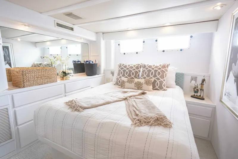  Yacht Photos Pics Luxurious 1989 Hatteras Custom Cockpit yacht bedroom with elegant decor and natural light.