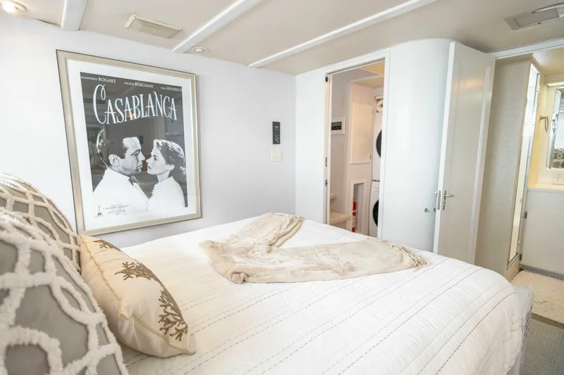  Yacht Photos Pics Bedroom interior of 1989 Hatteras Custom Cockpit yacht with Casablanca poster and cozy decor.