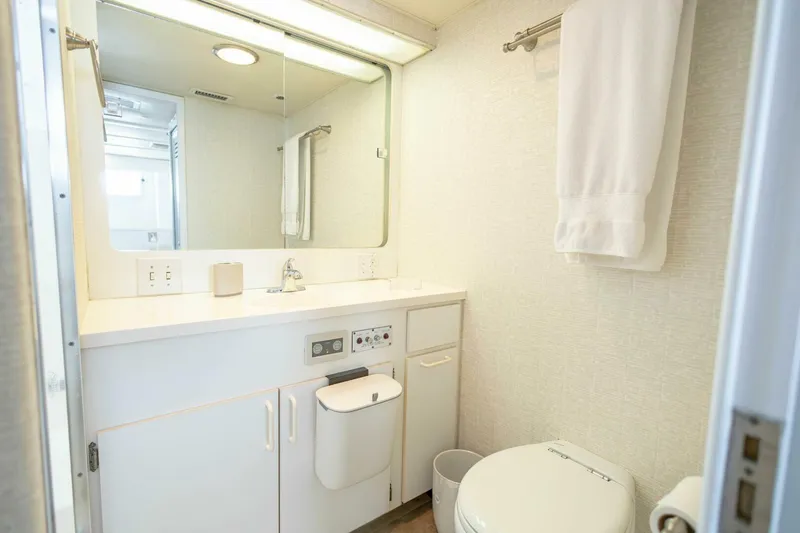  Yacht Photos Pics Bathroom interior of 1989 Hatteras Custom Cockpit yacht, featuring modern fixtures and white decor.