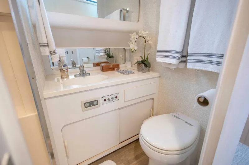  Yacht Photos Pics Luxurious 1989 Hatteras Custom Cockpit yacht bathroom with modern amenities and elegant decor.