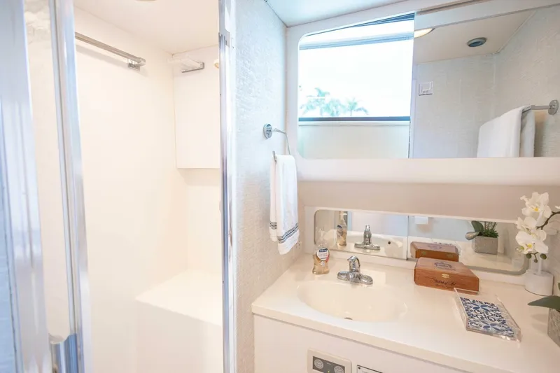  Yacht Photos Pics Luxurious bathroom in 1989 Hatteras Custom Cockpit yacht with modern fixtures and elegant decor.