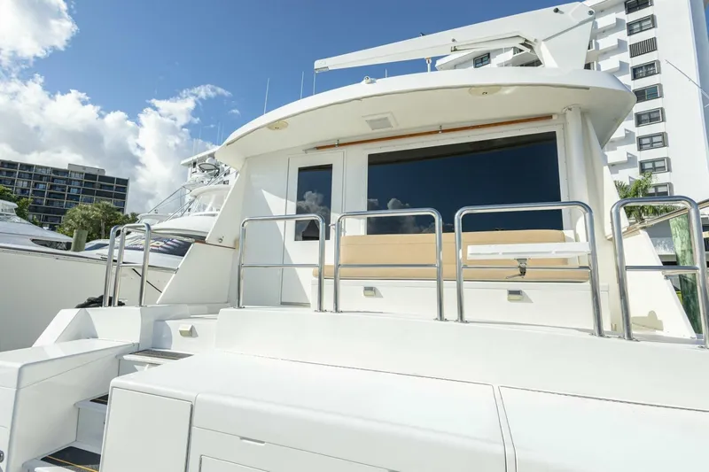  Yacht Photos Pics 1989 Hatteras Custom Cockpit yacht with sleek design and modern features, docked under blue sky.