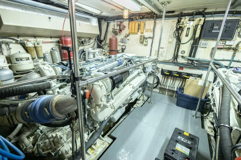  Yacht Photos Pics Engine room of 1989 Hatteras Custom Cockpit yacht, showcasing machinery and equipment.