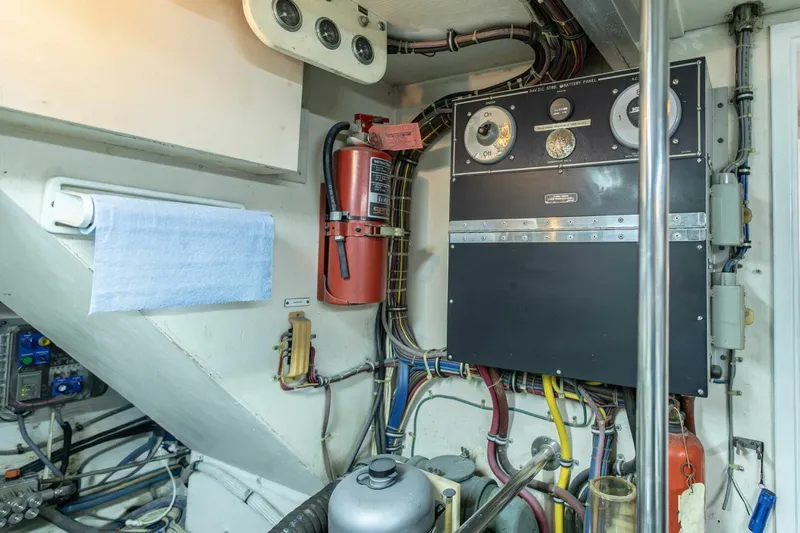  Yacht Photos Pics Engine room of 1989 Hatteras Custom Cockpit with control panel and fire extinguisher.