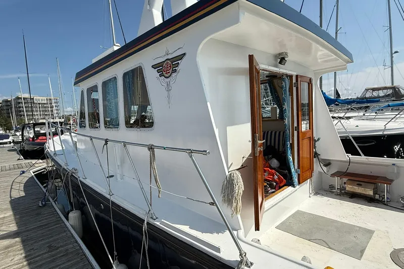  Yacht Photos Pics LEBLANC Leo 38 yacht, 2000 model, docked at marina with open cabin door.