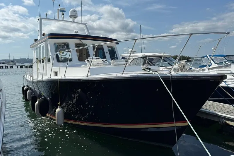 Yacht Photos Pics 2000 LEBLANC Leo 38 boat docked at marina under cloudy sky.