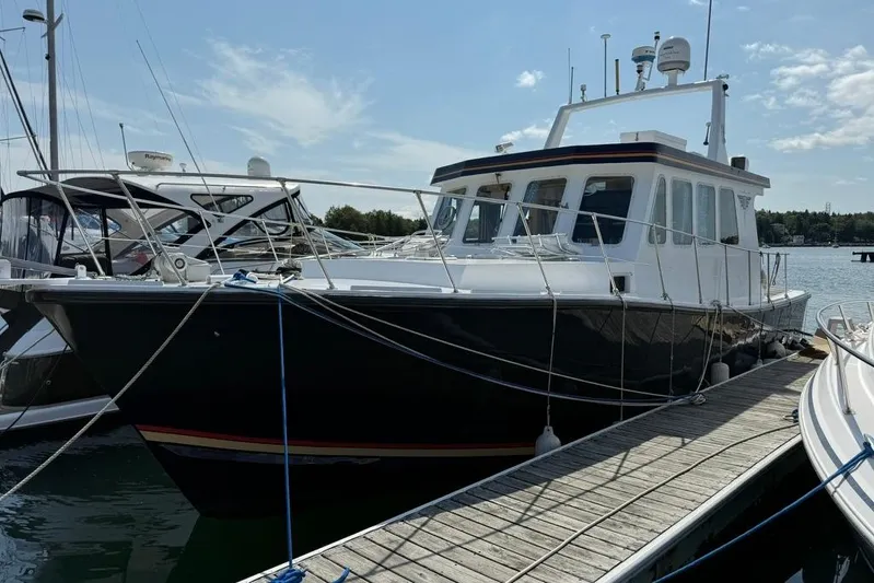  Yacht Photos Pics LEBLANC Leo 38 boat from 2000 docked at a marina under a clear sky.
