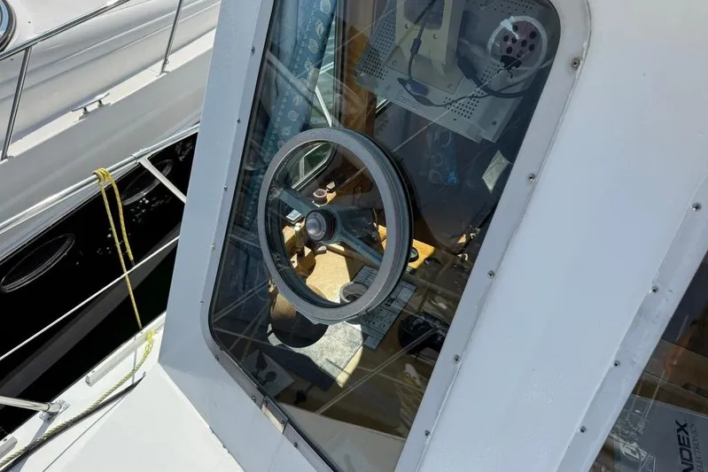  Yacht Photos Pics LEBLANC Leo 38 boat cockpit with steering wheel, 2000 model, docked beside another vessel.