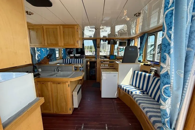  Yacht Photos Pics Interior of 2000 LEBLANC Leo 38 boat with wood cabinets and striped seating.