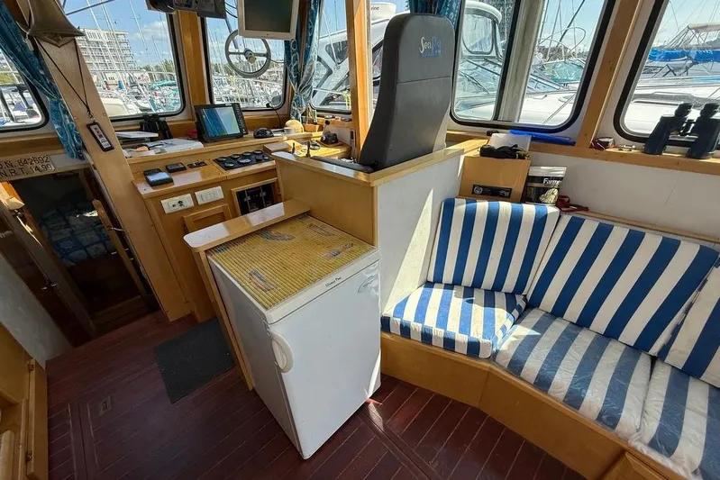  Yacht Photos Pics Interior of 2000 LEBLANC Leo 38 boat with striped seating and navigation equipment.