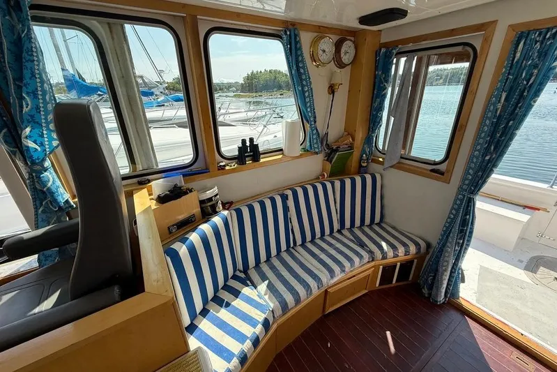  Yacht Photos Pics Interior of 2000 LEBLANC Leo 38 boat with striped seating and nautical decor.