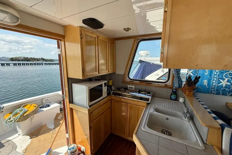  Yacht Photos Pics Cozy kitchen interior of 2000 LEBLANC Leo 38 boat with ocean view.