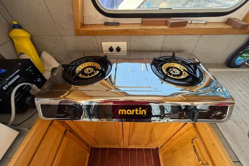  Yacht Photos Pics Two-burner gas stove in a boat kitchen, featuring a Martin brand design.
