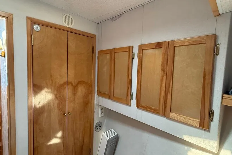  Yacht Photos Pics Wooden cabinets and closet in a 2000 LEBLANC Leo 38 interior.