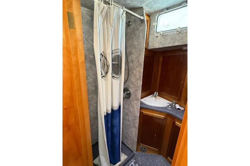  Yacht Photos Pics Compact bathroom in 2000 LEBLANC Leo 38 boat with shower and sink.