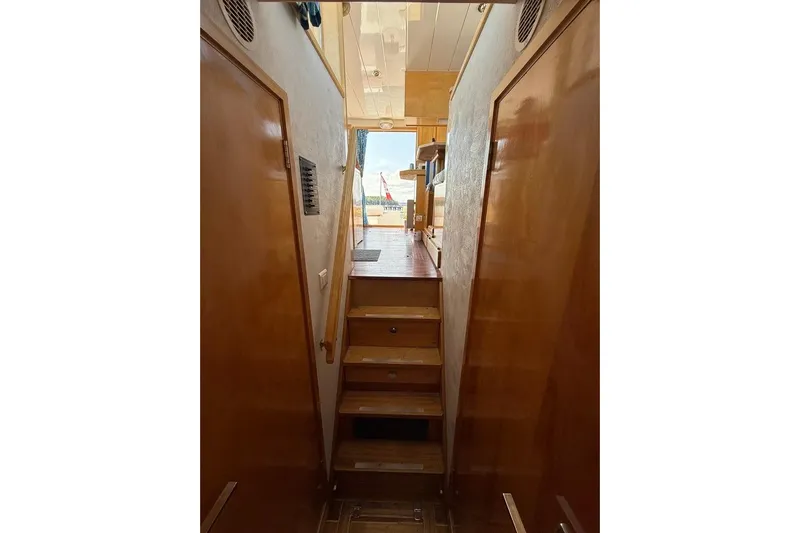  Yacht Photos Pics Interior view of 2000 LEBLANC Leo 38 yacht with wooden stairs and doors.