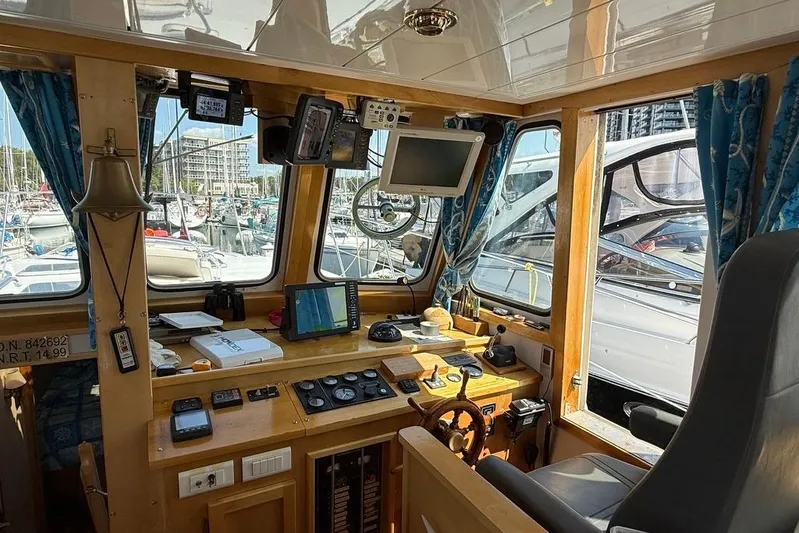  Yacht Photos Pics Interior of 2000 LEBLANC Leo 38 boat cockpit with navigation equipment and marina view.