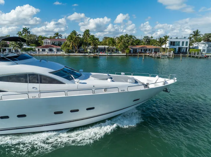 So What Who Cares Yacht Photos Pics Luxury Sunseeker 150 GT yacht cruising near waterfront homes, 2003 model.