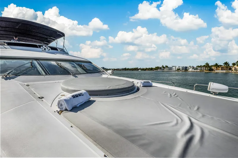 So What Who Cares Yacht Photos Pics Sunseeker 150 GT yacht deck, 2003 model, cruising on a sunny day with blue skies.