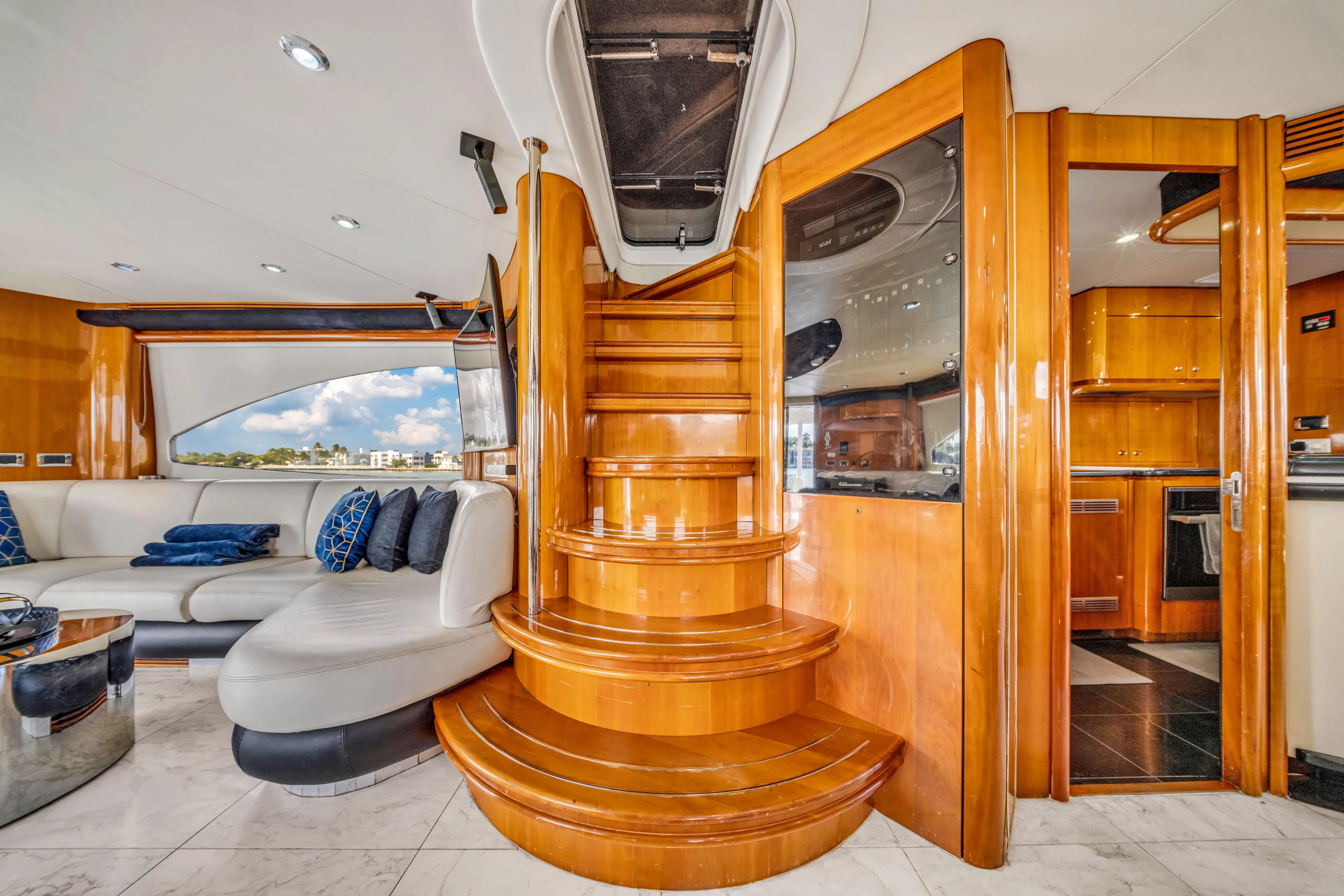 So What Who Cares Yacht Photos Pics Luxurious interior of 2003 Sunseeker 150 GT yacht with elegant wooden staircase.