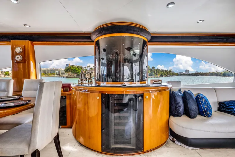 So What Who Cares Yacht Photos Pics Luxurious interior of 2003 Sunseeker 150 GT yacht with elegant seating and panoramic windows.