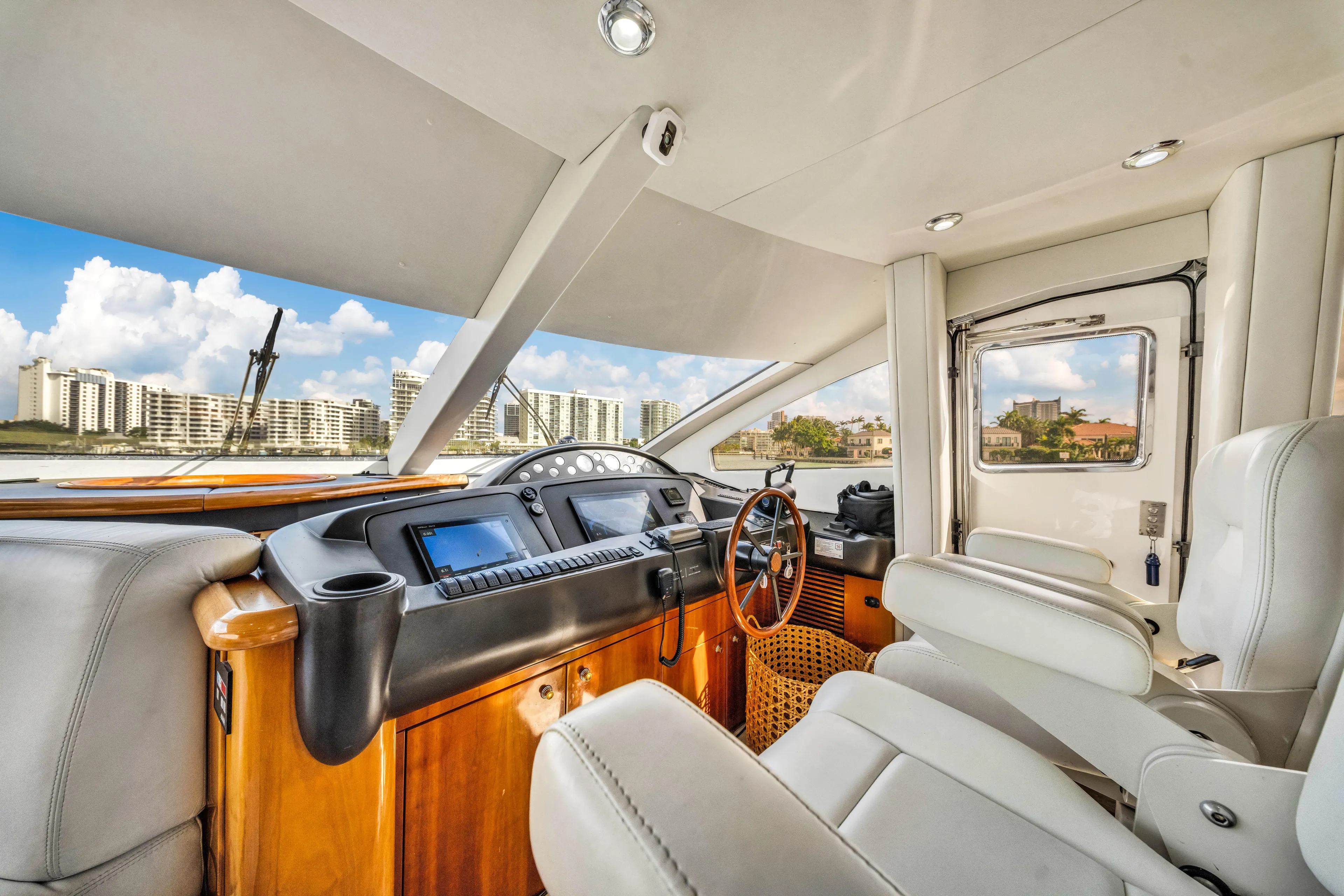 So What Who Cares Yacht Photos Pics Luxurious interior of 2003 Sunseeker 150 GT yacht with modern dashboard and plush seating.