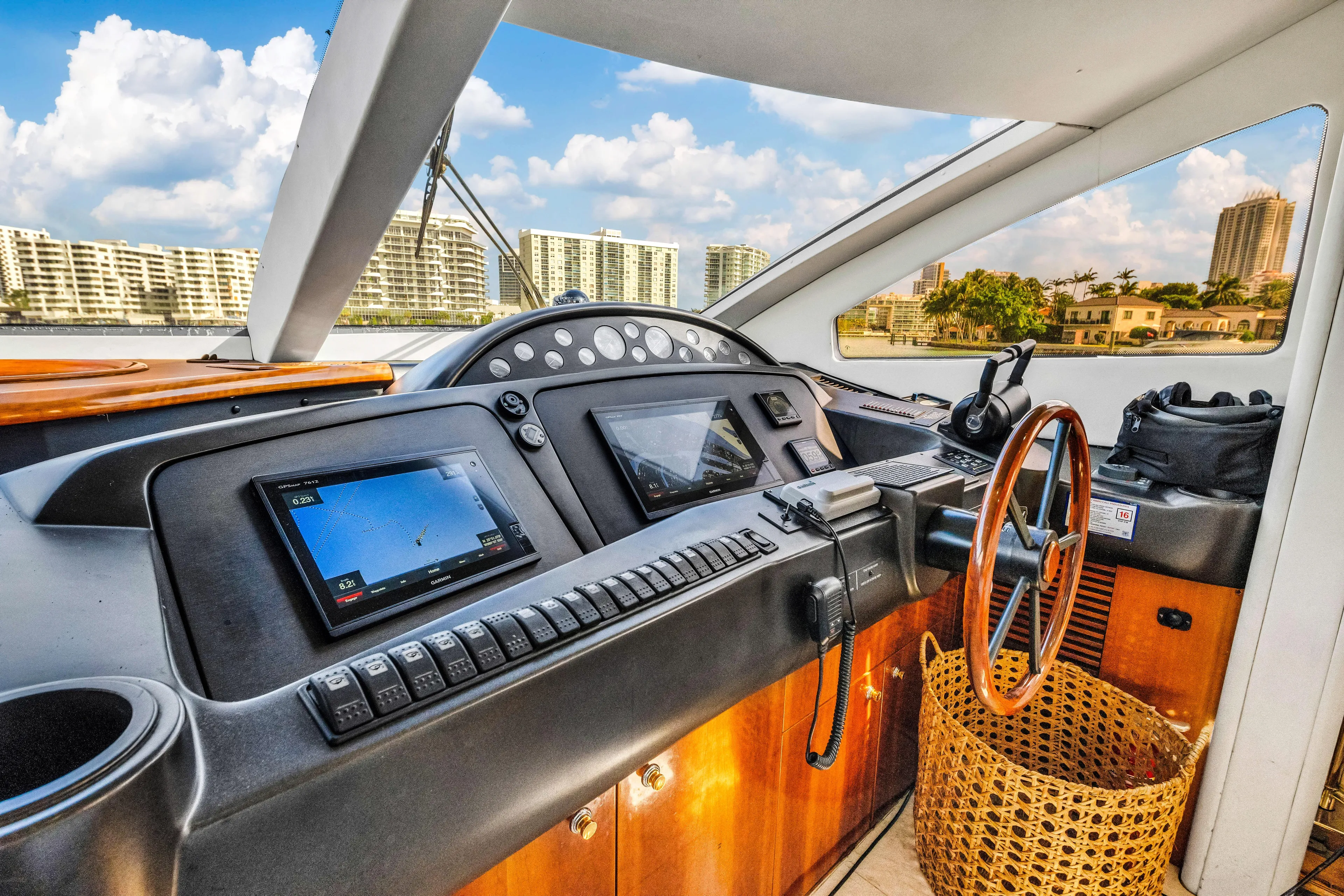 So What Who Cares Yacht Photos Pics Luxurious Sunseeker 150 GT yacht helm, 2003 model, with modern navigation equipment and scenic waterfront view.