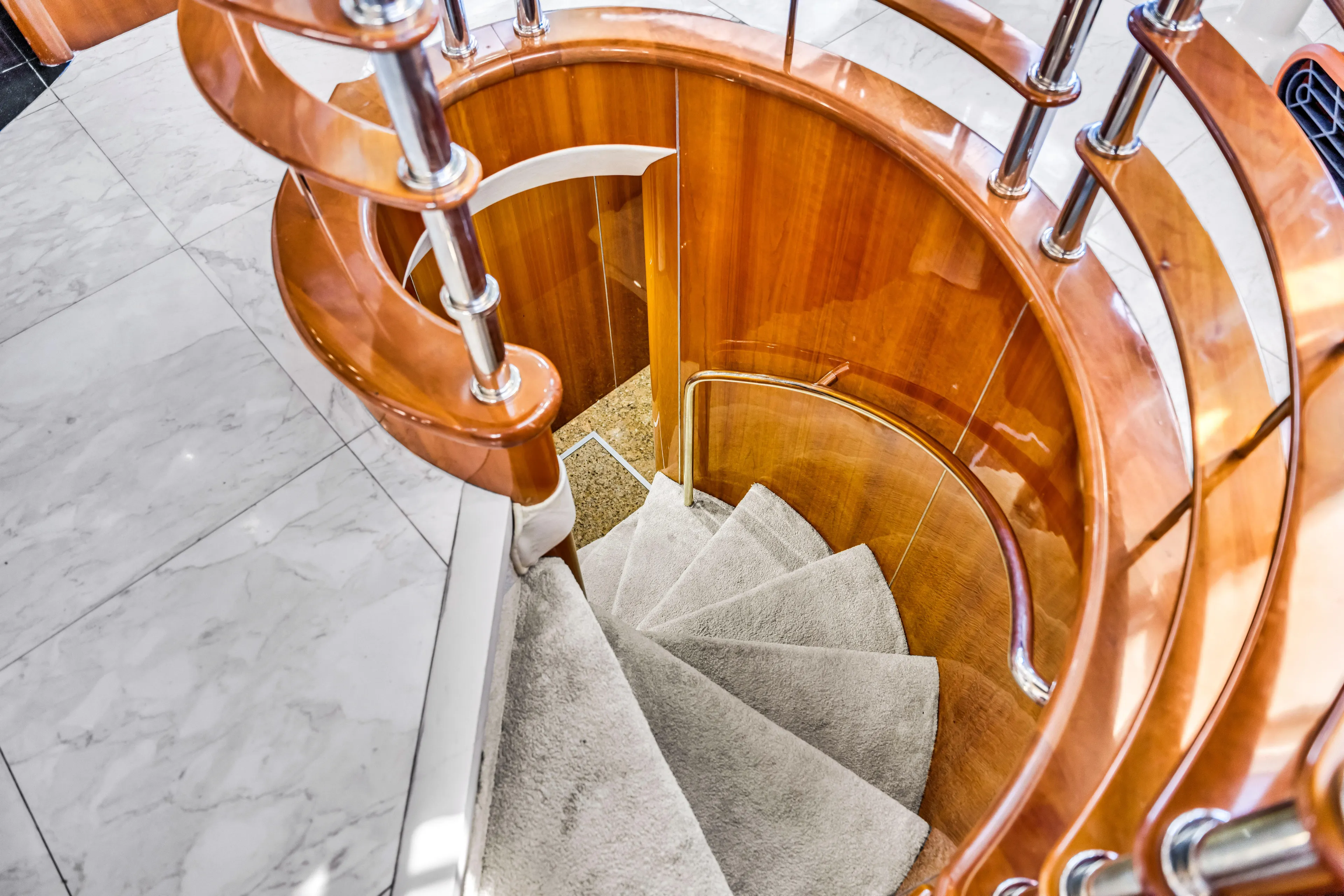 So What Who Cares Yacht Photos Pics Curved wooden staircase on 2003 Sunseeker 150 GT yacht interior.