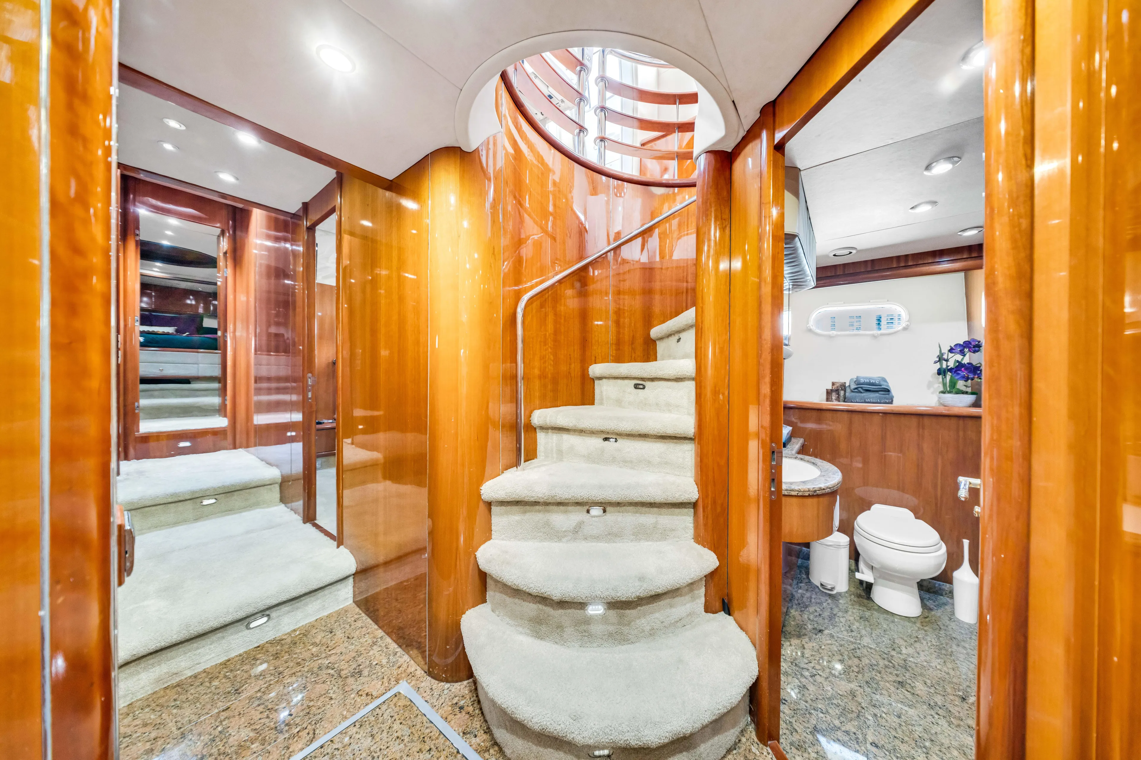 So What Who Cares Yacht Photos Pics Luxurious interior of 2003 Sunseeker 150 GT yacht with elegant staircase and modern bathroom.