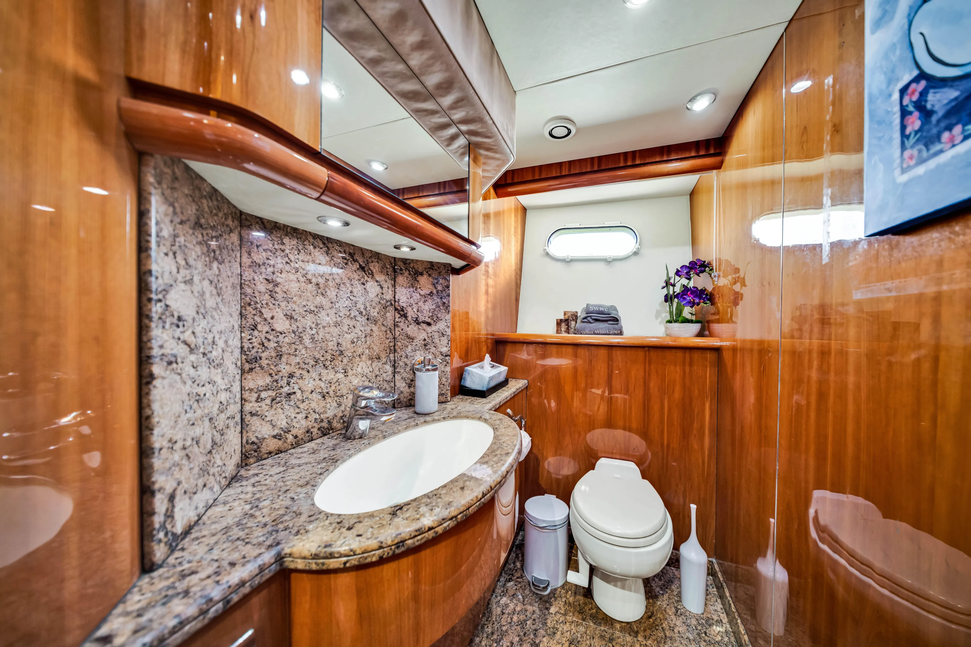 So What Who Cares Yacht Photos Pics Luxurious bathroom in 2003 Sunseeker 150 GT yacht with wood paneling and granite surfaces.