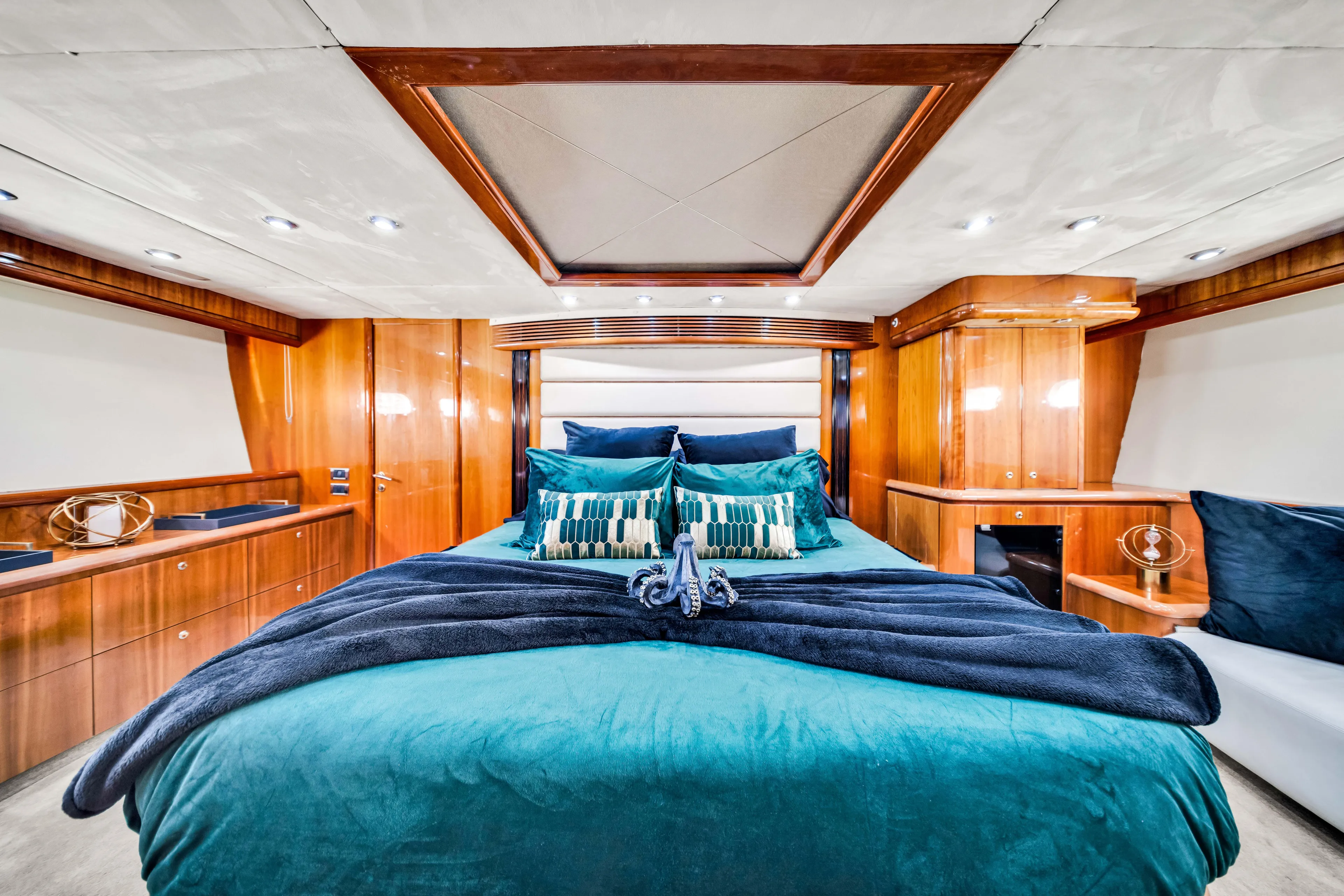 So What Who Cares Yacht Photos Pics Luxurious cabin interior of 2003 Sunseeker 150 GT yacht with elegant wood paneling.