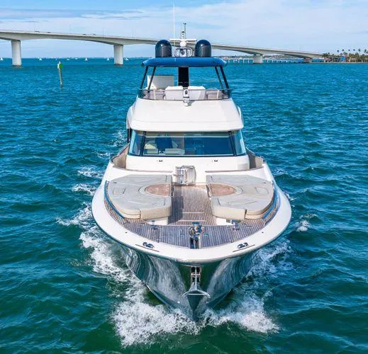  Yacht Photos Pics 2018 Monte Carlo Yachts MCY 70 cruising on blue waters near a bridge.