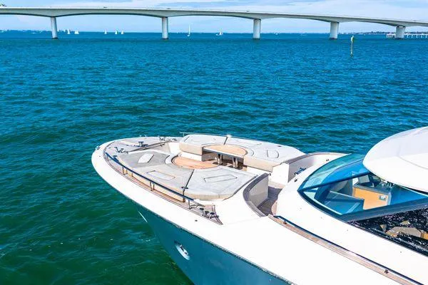  Yacht Photos Pics Monte Carlo Yachts MCY 70, 2018 model, cruising on blue waters near a bridge.