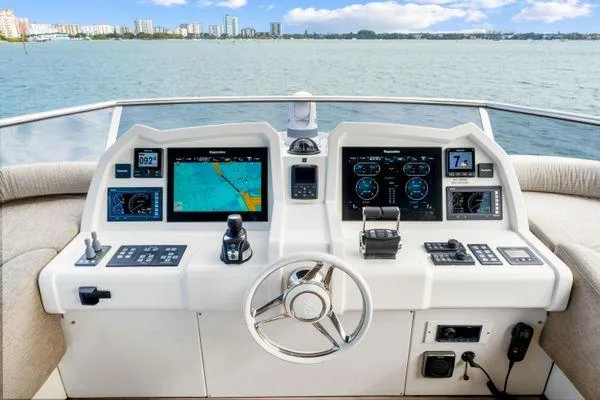  Yacht Photos Pics Cockpit of 2018 Monte Carlo Yachts MCY 70 with navigation displays and steering wheel.