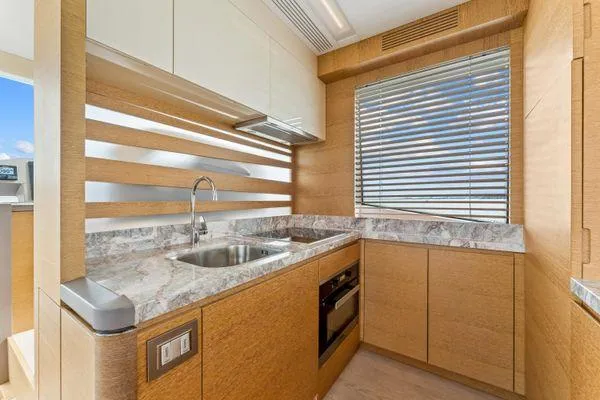  Yacht Photos Pics Luxurious kitchen interior of 2018 Monte Carlo Yachts MCY 70 with modern design and marble countertops.