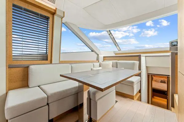  Yacht Photos Pics Luxurious interior of 2018 Monte Carlo Yachts MCY 70 with elegant seating and panoramic windows.