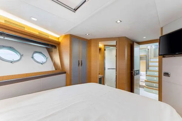  Yacht Photos Pics Luxurious bedroom interior of 2018 Monte Carlo Yachts MCY 70 with modern design and porthole windows.