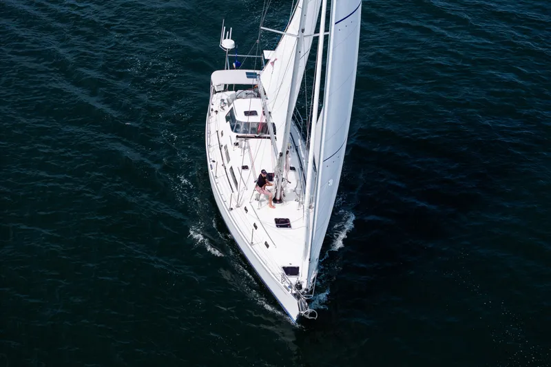 Boojum Yacht Photos Pics Aerial view of 2024 Outbound 46 sailboat navigating through deep blue waters.