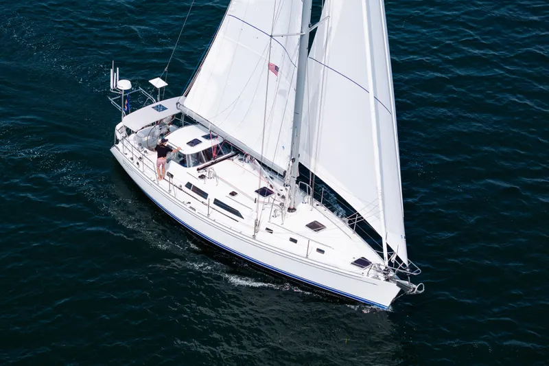 Boojum Yacht Photos Pics 2024 Outbound 46 sailboat cruising on open water with full sails.