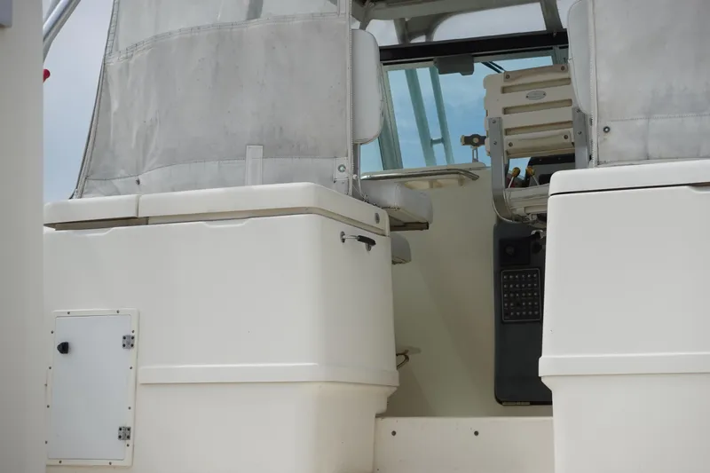  Yacht Photos Pics 1997 Pursuit 3400 Offshore boat cockpit with seating and control panel.