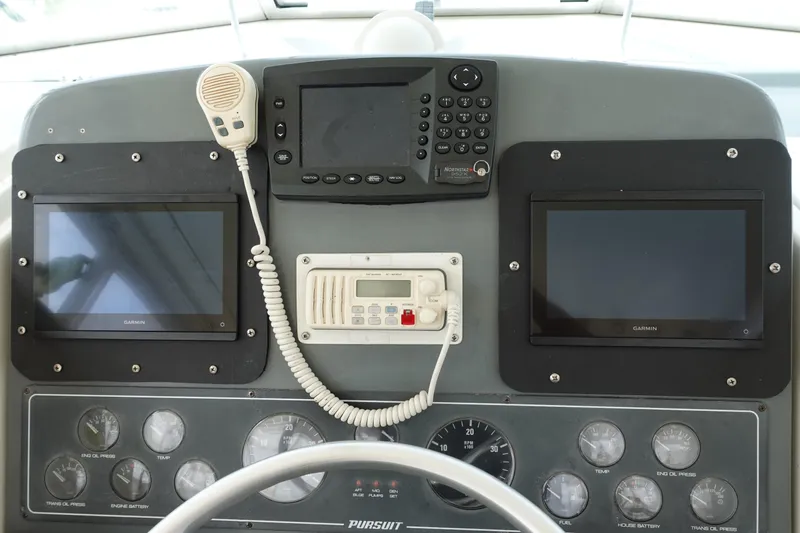  Yacht Photos Pics Control panel of a 1997 Pursuit 3400 Offshore boat with Garmin displays and gauges.