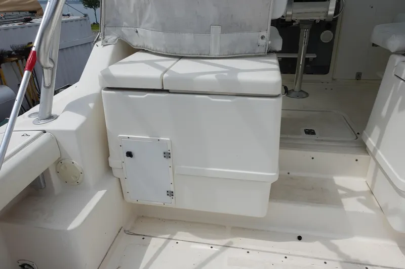  Yacht Photos Pics 1997 Pursuit 3400 Offshore boat interior with storage compartment and seating area.