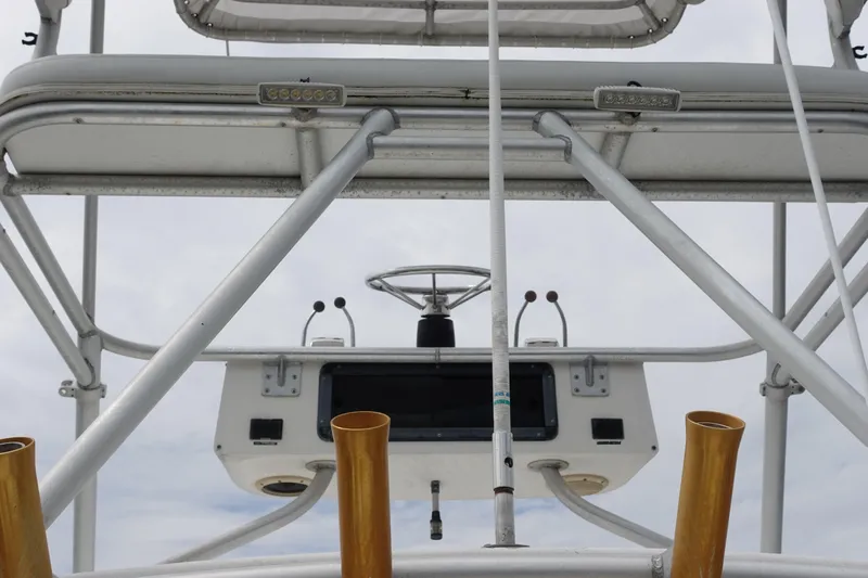  Yacht Photos Pics 1997 Pursuit 3400 Offshore boat helm with steering wheel and controls.