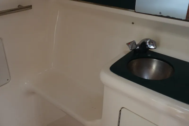  Yacht Photos Pics Interior of 1997 Pursuit 3400 Offshore boat with sink and seating area.