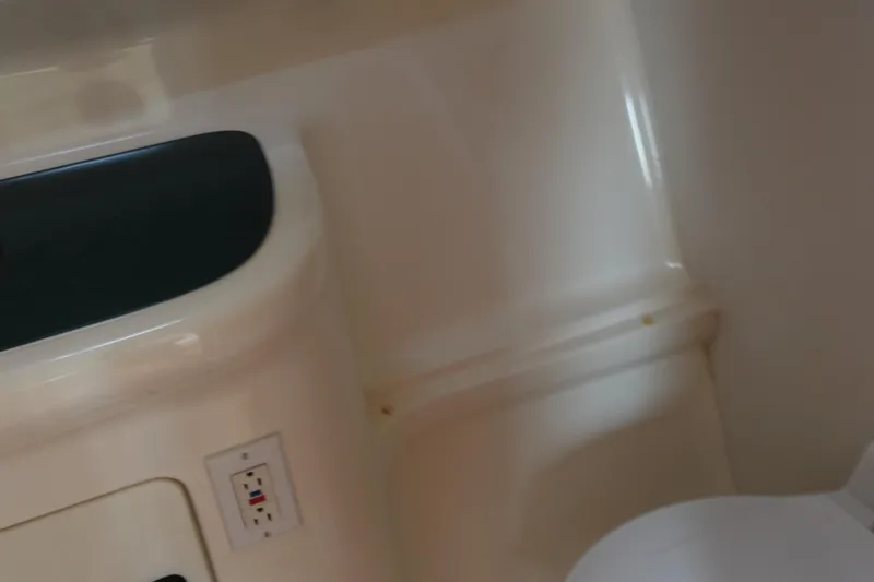  Yacht Photos Pics 1997 Pursuit 3400 Offshore interior detail with electrical outlet and seating.