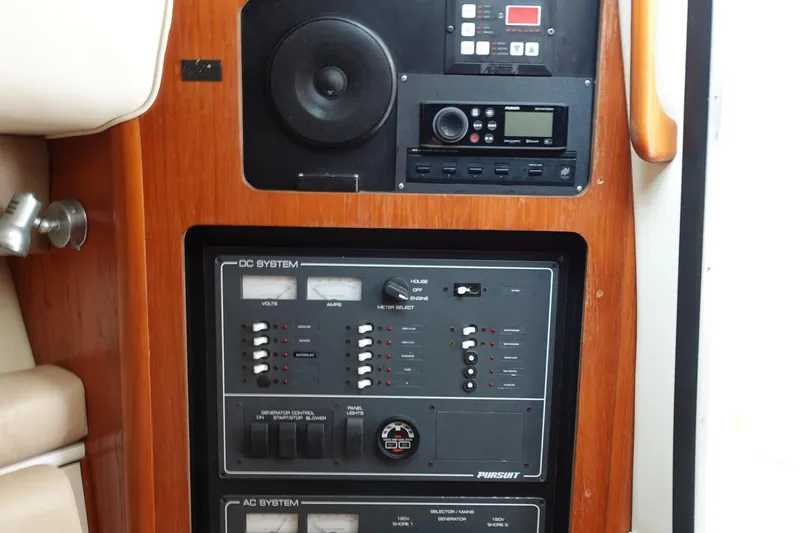  Yacht Photos Pics Control panel of a 1997 Pursuit 3400 Offshore boat, featuring DC and AC systems.