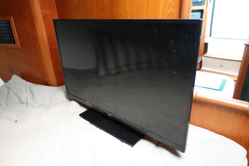  Yacht Photos Pics Flat-screen TV inside 1997 Pursuit 3400 Offshore boat cabin, wooden interior.